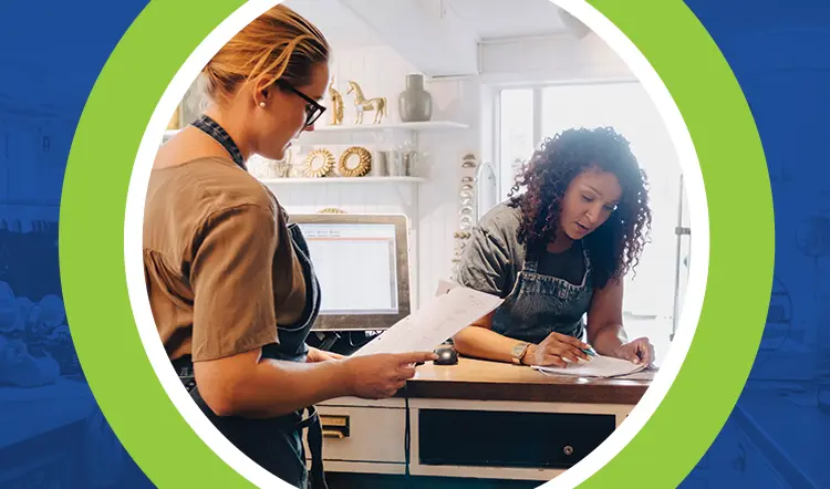 Photo of 2 women working on project.