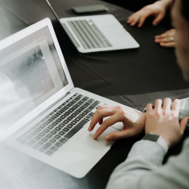 hands typing on laptop PC