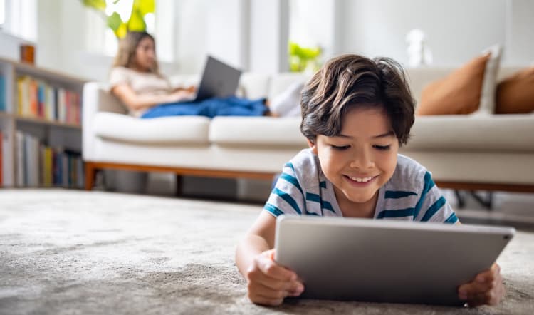Child working on laptop PC.