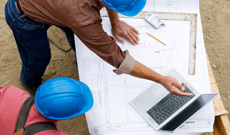 construction workers looking at blueprint