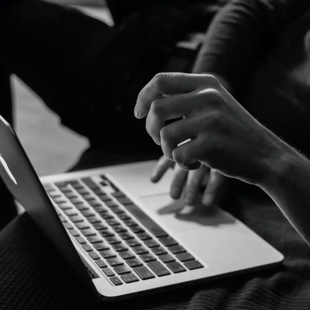 Photo of hands typing on keyboard.